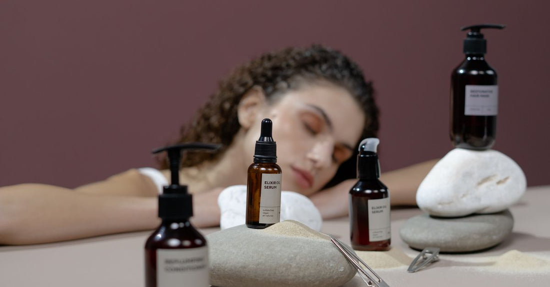 Bottles of scalp treatment serums on a white marble surface, illustrating how to choose scalp treatments UK.
