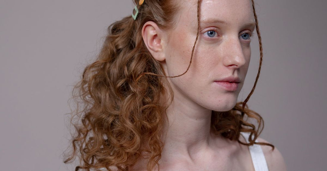 Assorted damage-free hair clips including claw, duckbill and automatic styles laid flat on a neutral background, illustrating a clips buying guide for healthy hair.