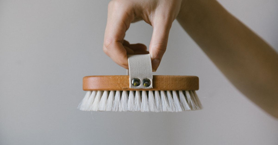 A selection of bath and body brushes with wooden handles and natural bristles, illustrating how to choose bath & body brushes for different skin types.