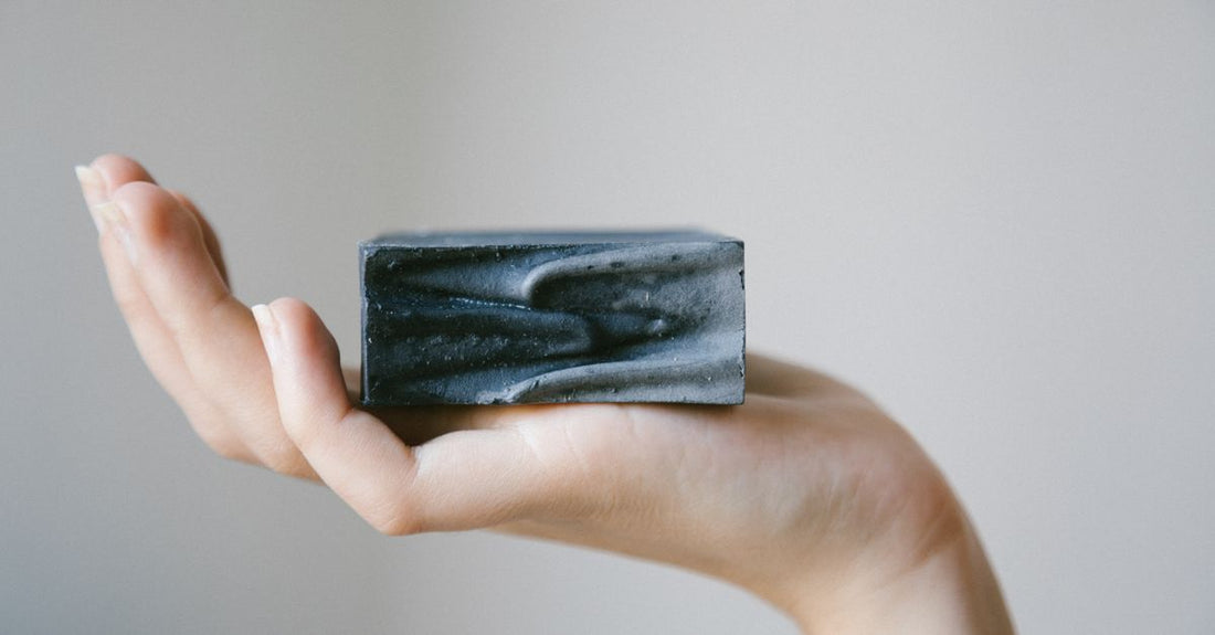 A selection of cleansing bars on a bathroom shelf, illustrating our bars buying guide for budget-conscious UK skincare enthusiasts.