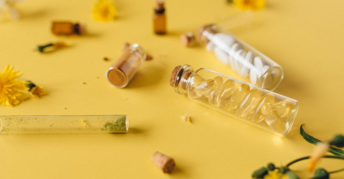 Glass bottles of single homeopathic remedies on a white shelf, illustrating a buying guide for UK shoppers.