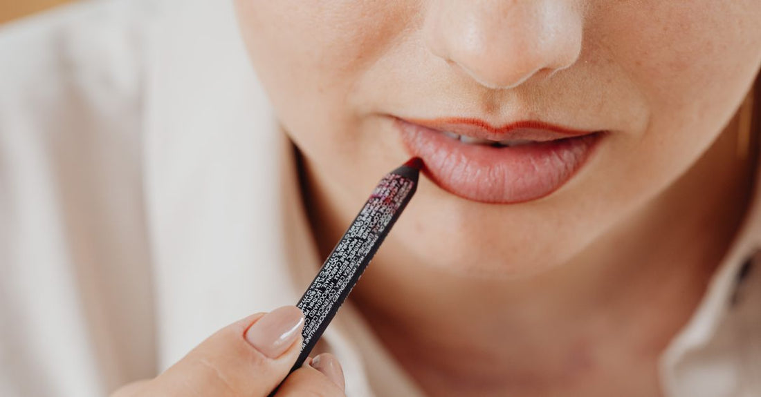 A sharp lip liner pencil resting on a cool marble surface, illustrating how to apply lip liner correctly for precise definition.