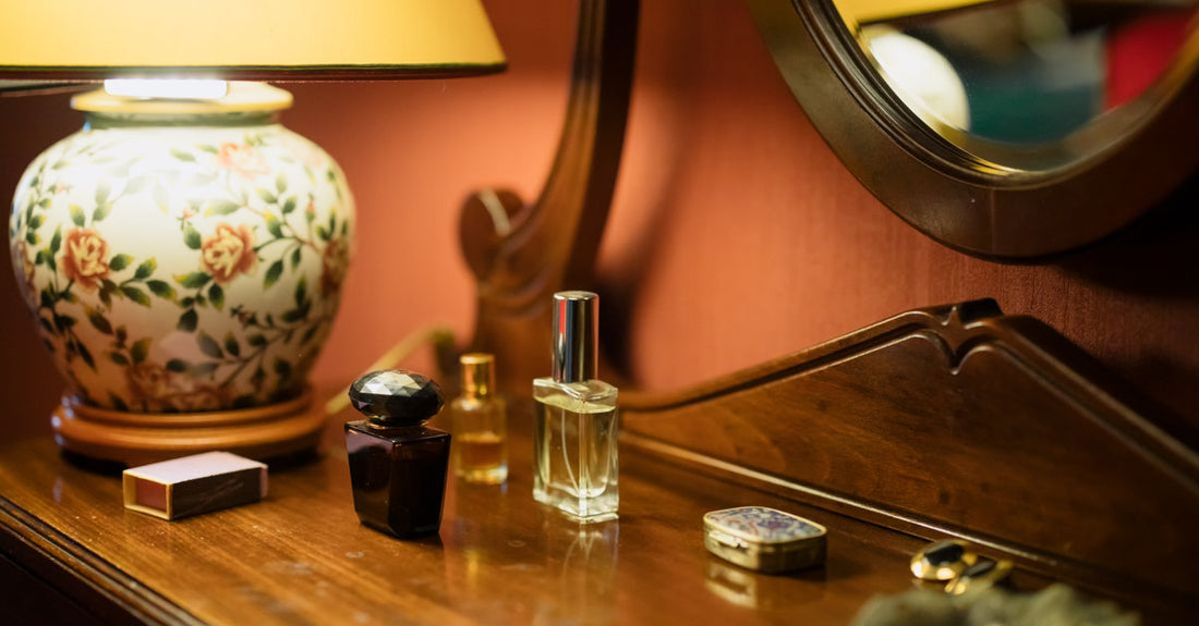 A flatlay of best cologne 2026 bottles with sampler vials and scent notes cards on a neutral background.