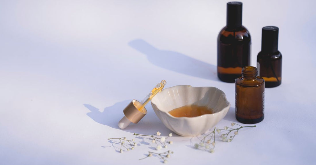 A glass bottle of hydrating face serum on a marble surface, representing the best face serum for dry skin UK.