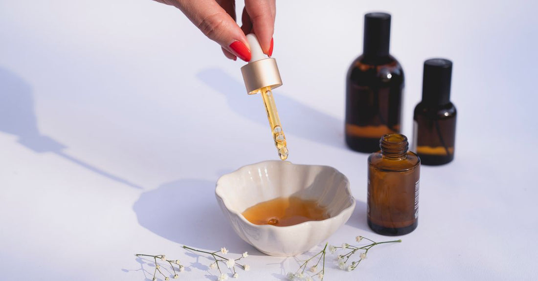A flatlay of best cuticle oils 2026 with droppers and brushes on a marble surface