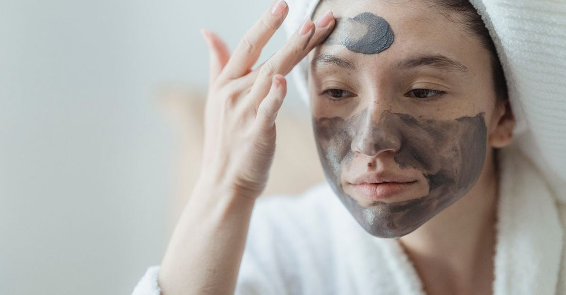 Assorted face masks buying guide flatlay showing sheet masks, clay masks and hydrogel masks on a clean white surface with skincare tools.