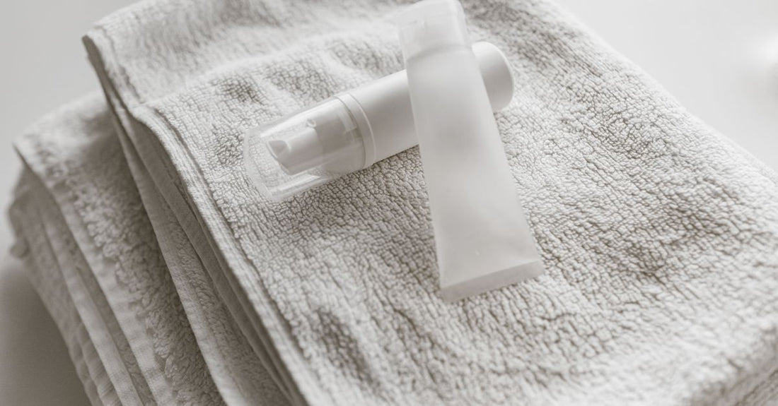 Medicube drying lotion and spot patches comparison flatlay on a clean surface, showing the pink sediment and translucent patches.