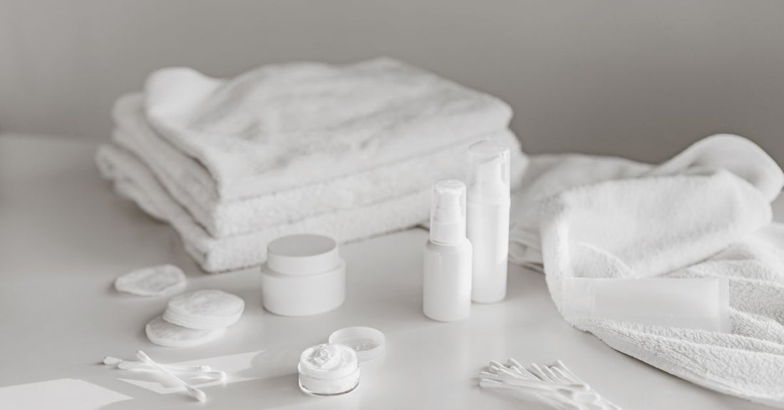 A flatlay of best aftercare products 2026 including creams, sprays, and balms on a neutral background.