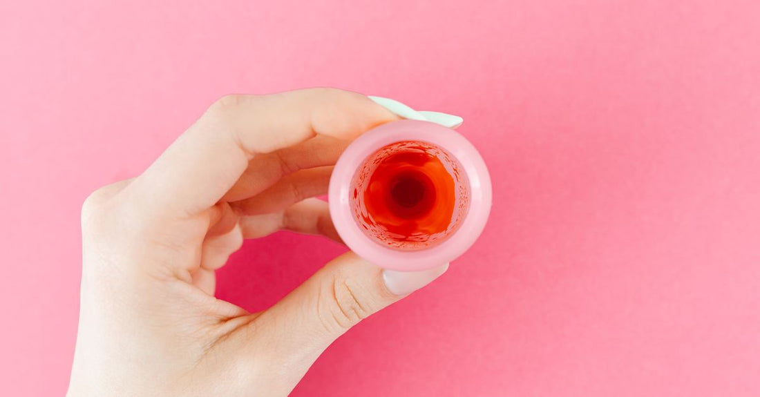 Silicone lip plumping device held against a soft pink background, demonstrating how to choose lip plumping devices for home use