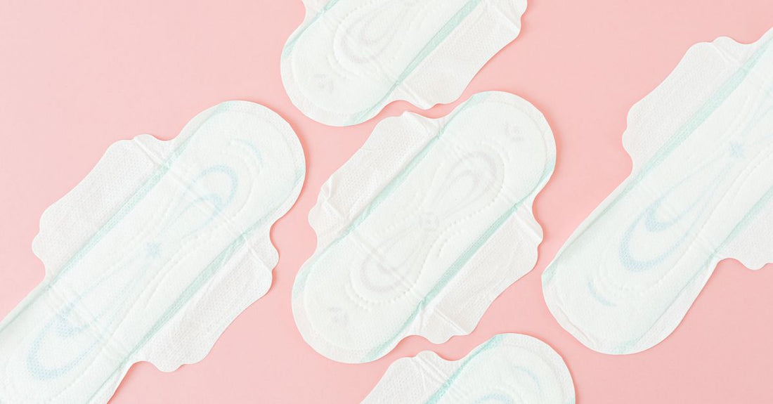 A stack of pure white cotton pads and rounds on a clean surface, illustrating how to choose cotton pads and rounds UK for skincare.