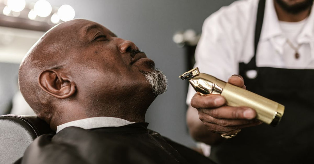Silver and black beard & mustache trimmer on a clean white background, showing precision blades.