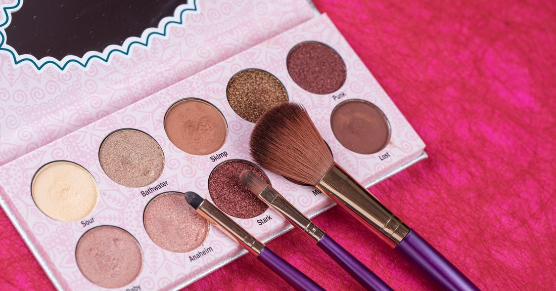 A flatlay of professional eyeshadow brushes including blending, shader, and crease brushes on a white surface, illustrating the best eyeshadow brushes 2026.