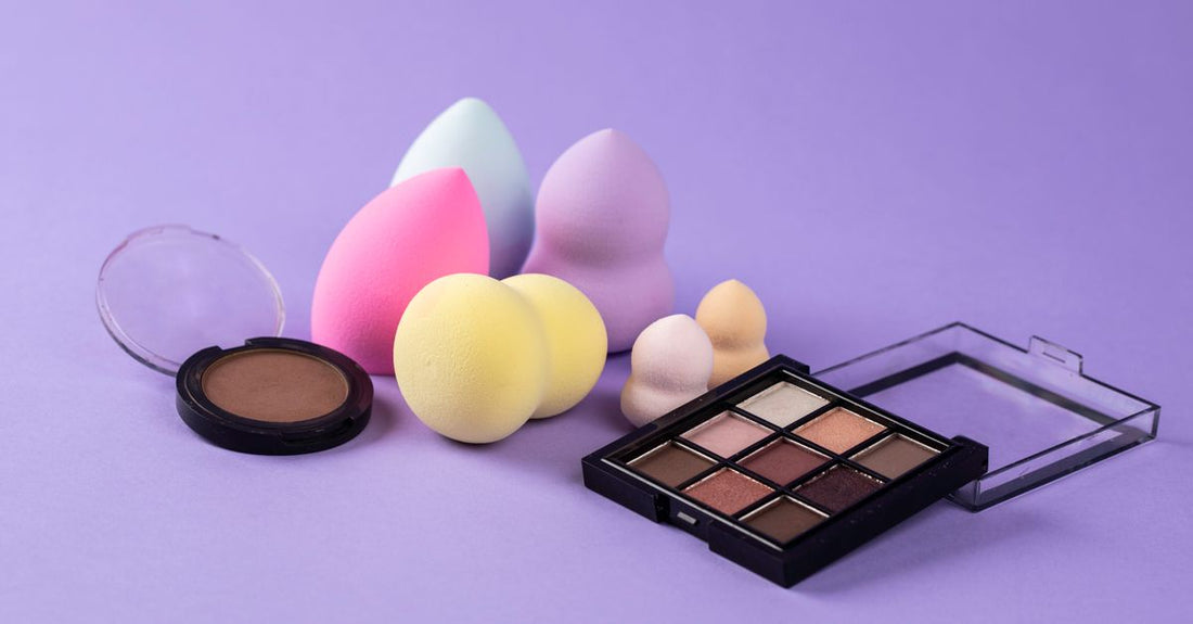 A close-up of several damp makeup sponges in a flatlay arrangement, demonstrating different textures for the best makeup sponge for foundation UK.
