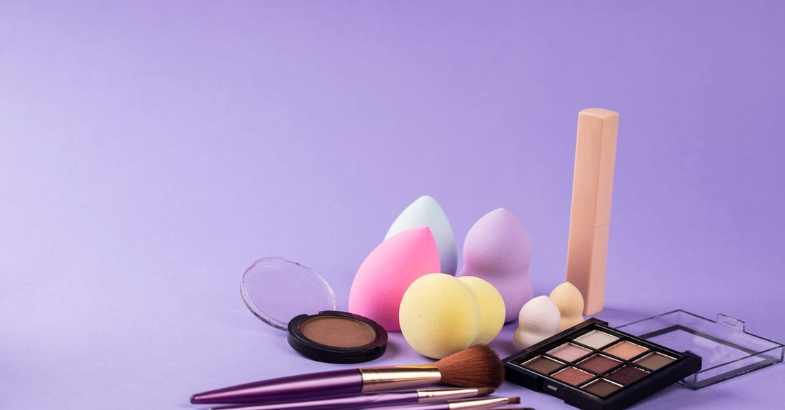 A damp beauty blender sponge resting on a clean white surface, ready for foundation application.