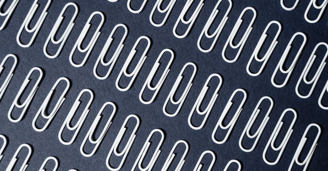A selection of metal and plastic barrettes laid out on a neutral background, demonstrating different sizes and clasp mechanisms for various UK hair types.
