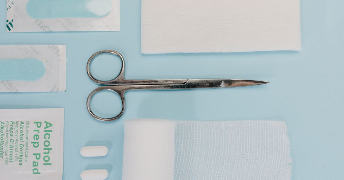 A clean flatlay of professional ingrown toenail tools including a clipper, lifter, and file on a white surface.