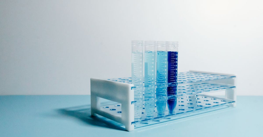 Professional hair colour tubes and developer bottles arranged on a white bathroom shelf, illustrating best hair color 2026 products