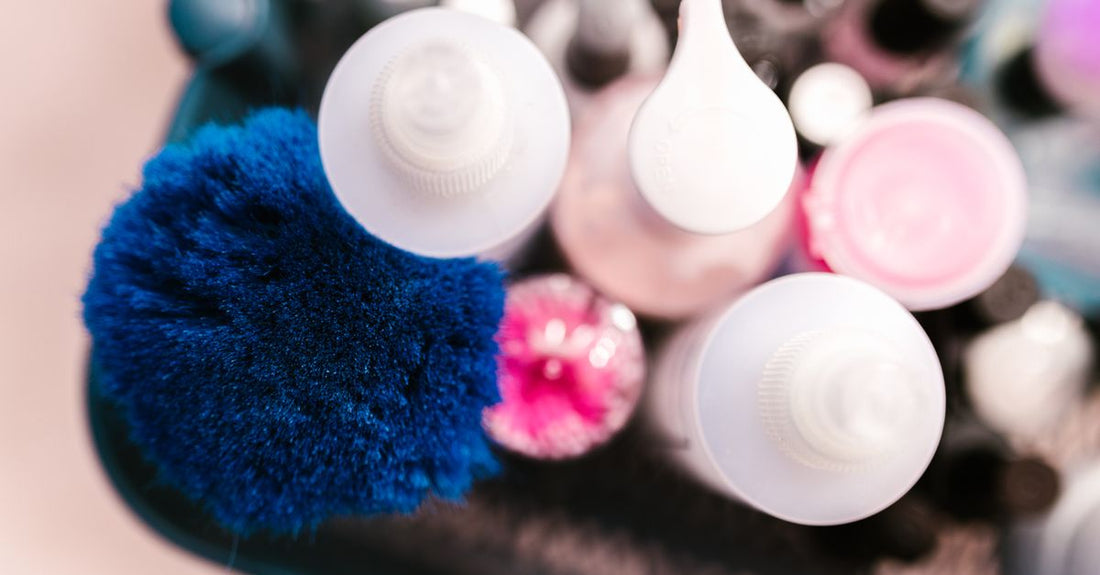 A flatlay photograph of natural bristle and silicone bath & body brushes on a neutral background, illustrating a bath & body brushes buying guide.