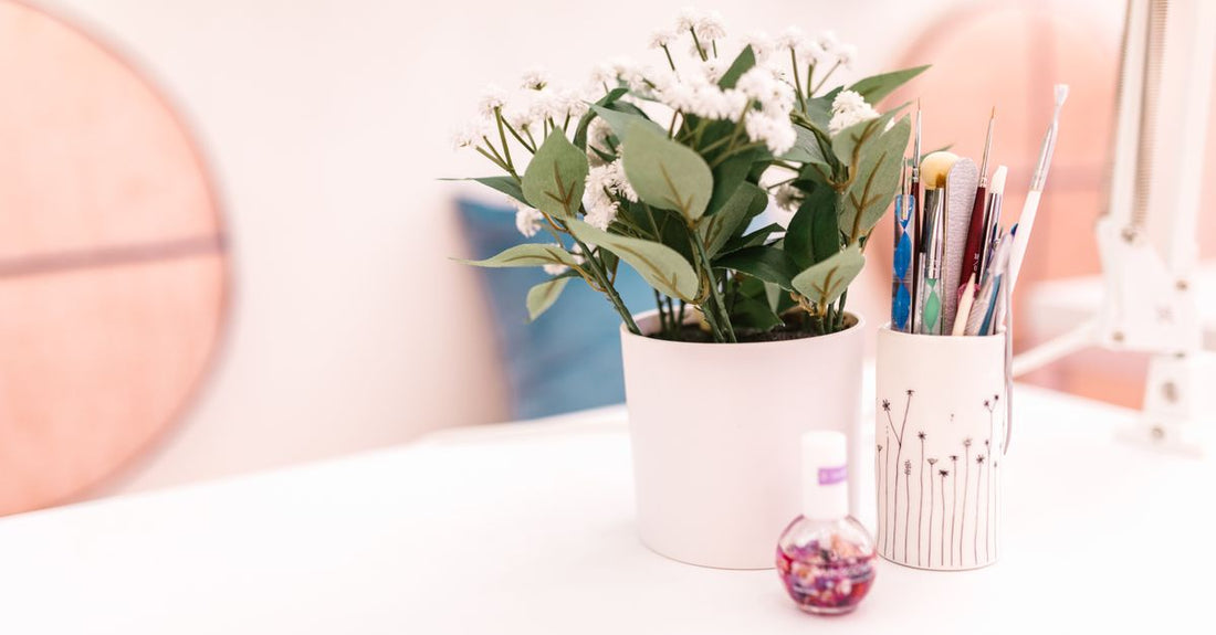 A selection of colourful nail polish bottles arranged on a clean surface, illustrating how to make nail polish last longer with the right products.