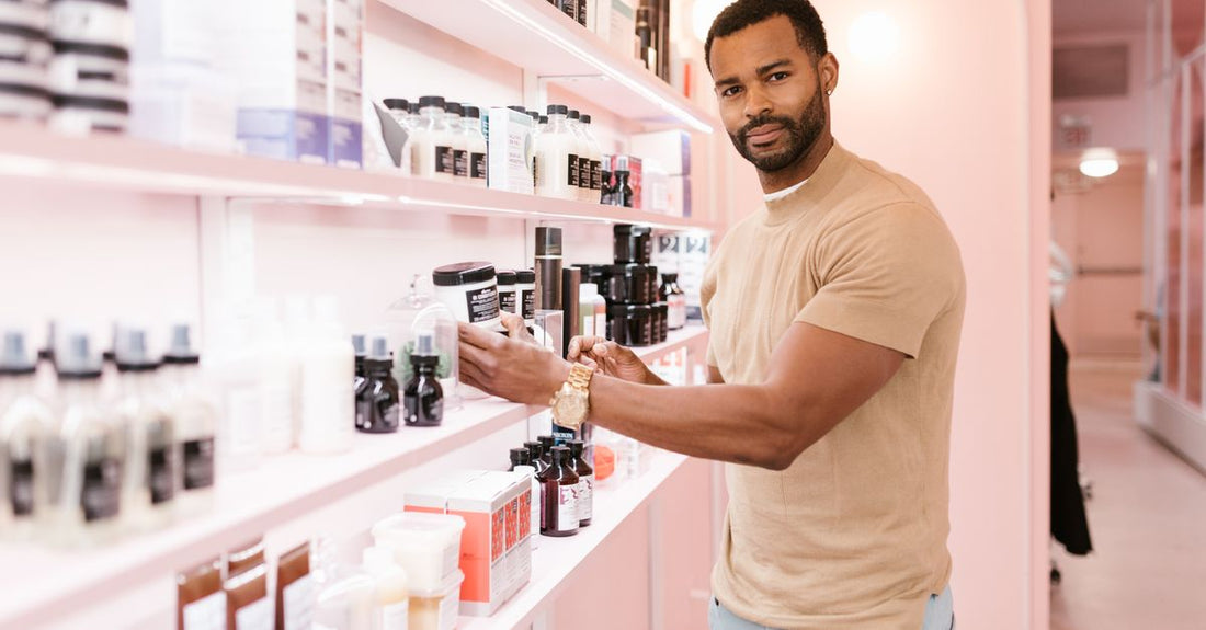 Beard conditioners and oils buying guide: bottles of beard conditioner and oil arranged on a wooden shelf, demonstrating a complete beard care kit.