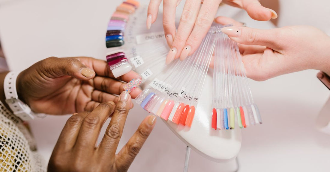 A flatlay of colourful gel polish bottles on a white surface, illustrating how to choose gel polish in the UK.