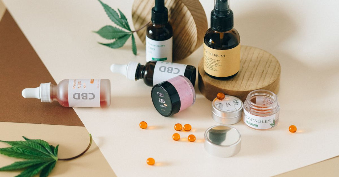 Two glass serum bottles with droppers, one amber and one clear, on a white marble surface, representing niacinamide vs vitamin C skincare choice.