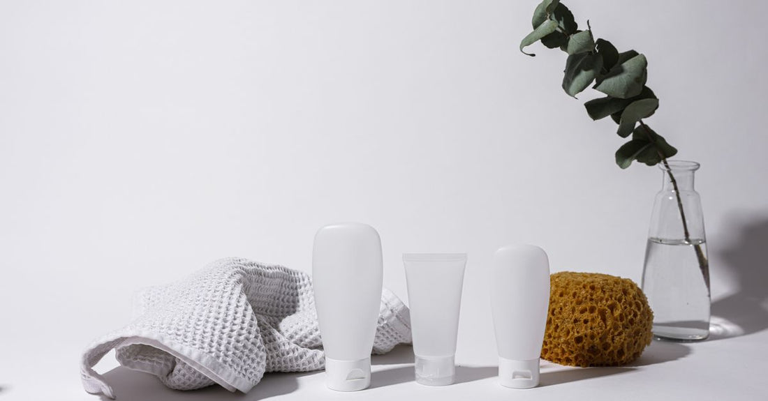A selection of tinted moisturiser bottles displayed on a light surface, illustrating the tinted moisturisers buying guide UK for choosing the right shade and formula.