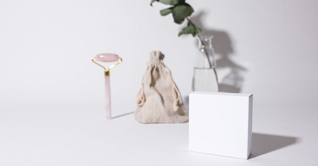 A flatlay of colourful cosmetic bags and makeup brushes on a white background, illustrating the best cosmetic bags 2026 selection.