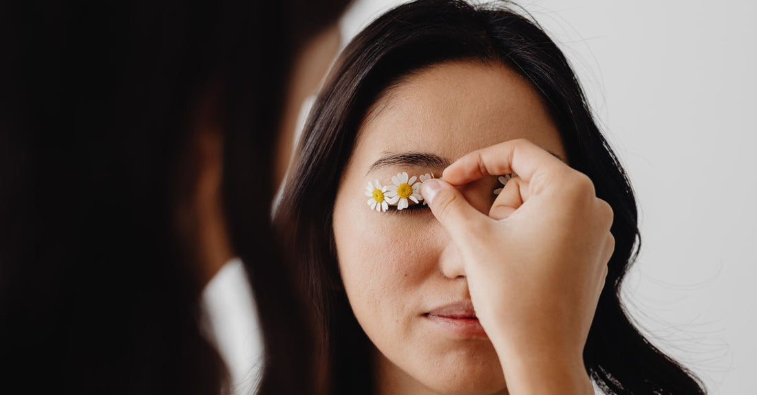 A flatlay display of various false eyelash styles on a neutral background, illustrating how to choose false lashes for different eye shapes.