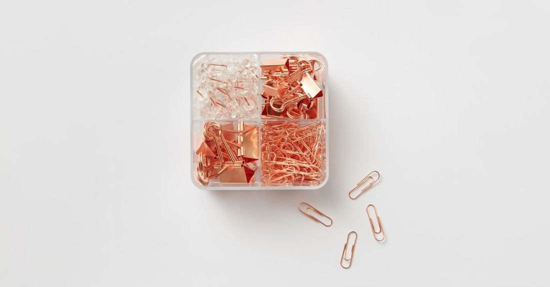 A flatlay of assorted hair claw clips in different colours and sizes on a white background, illustrating a claws buying guide.