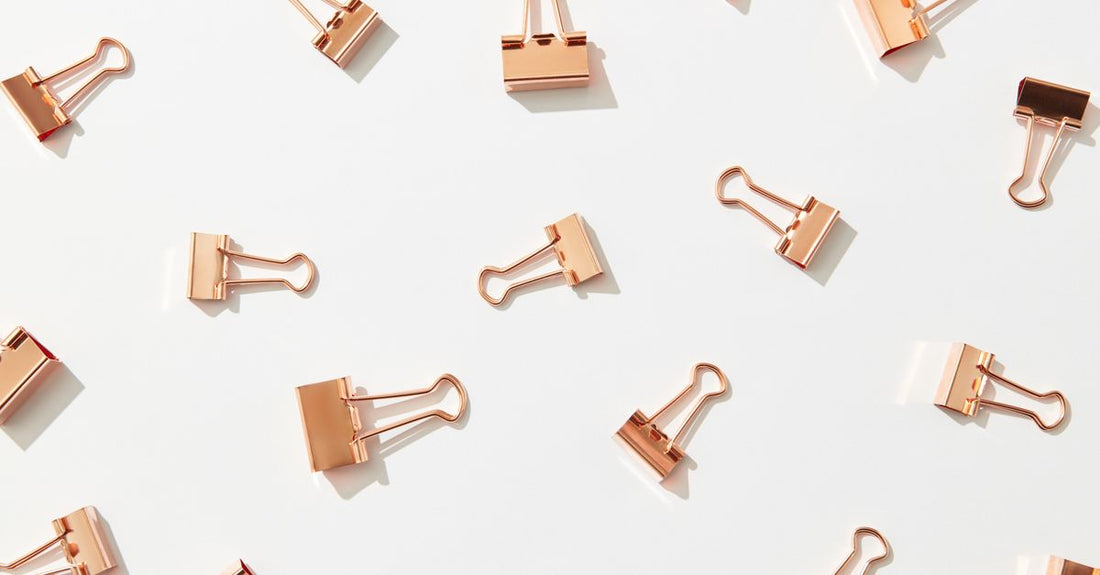 A flatlay of various hair clips including claw clips, snap clips, and duckbill clips, illustrating a clips buying guide.