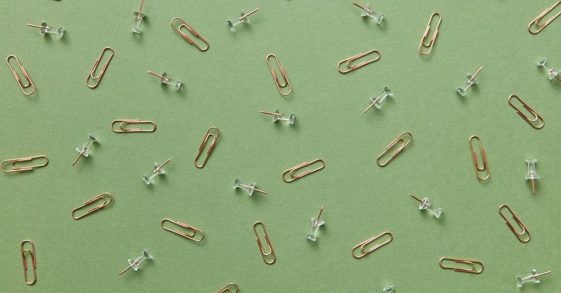Assorted high-quality metal hair clips arranged on a surface, representing the best clips 2026 for long-term hold and styling durability.
