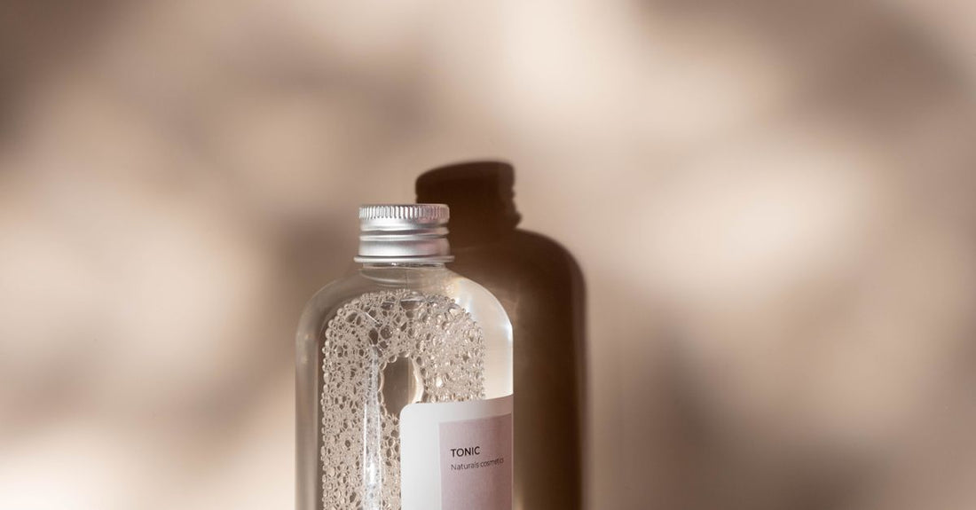 Hair tonic bottle on a neutral surface, illustrating how to use hair tonic for hair loss