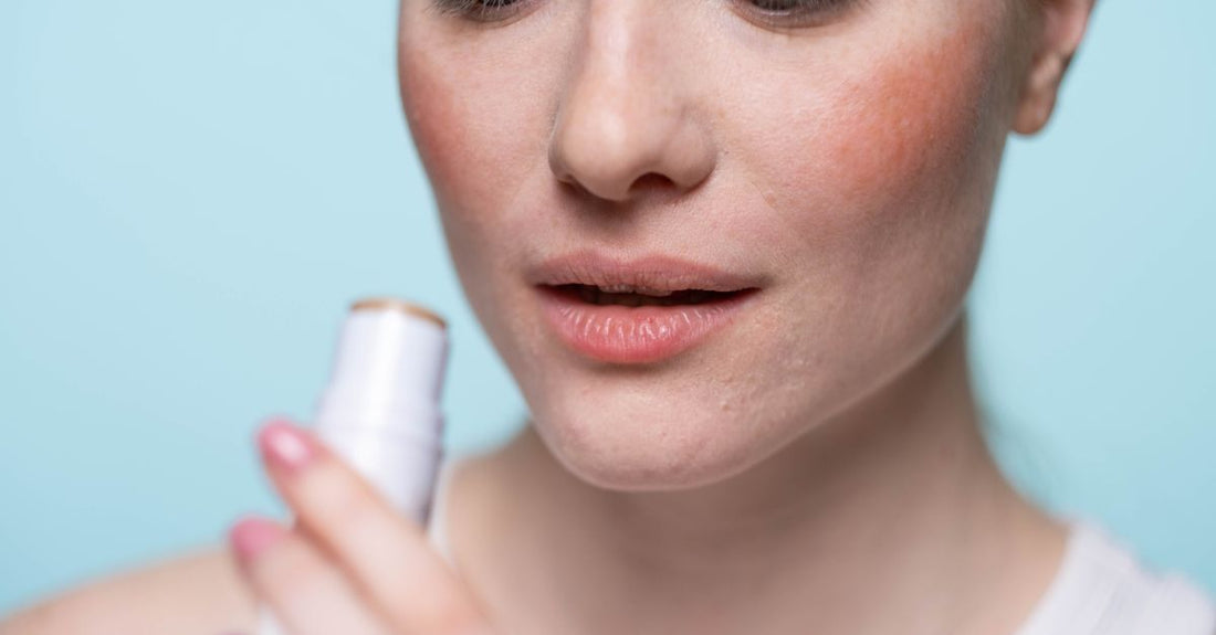 A collection of moisturising lip balm sticks on a white marble surface, representing the search for the best lip balm for chapped lips.