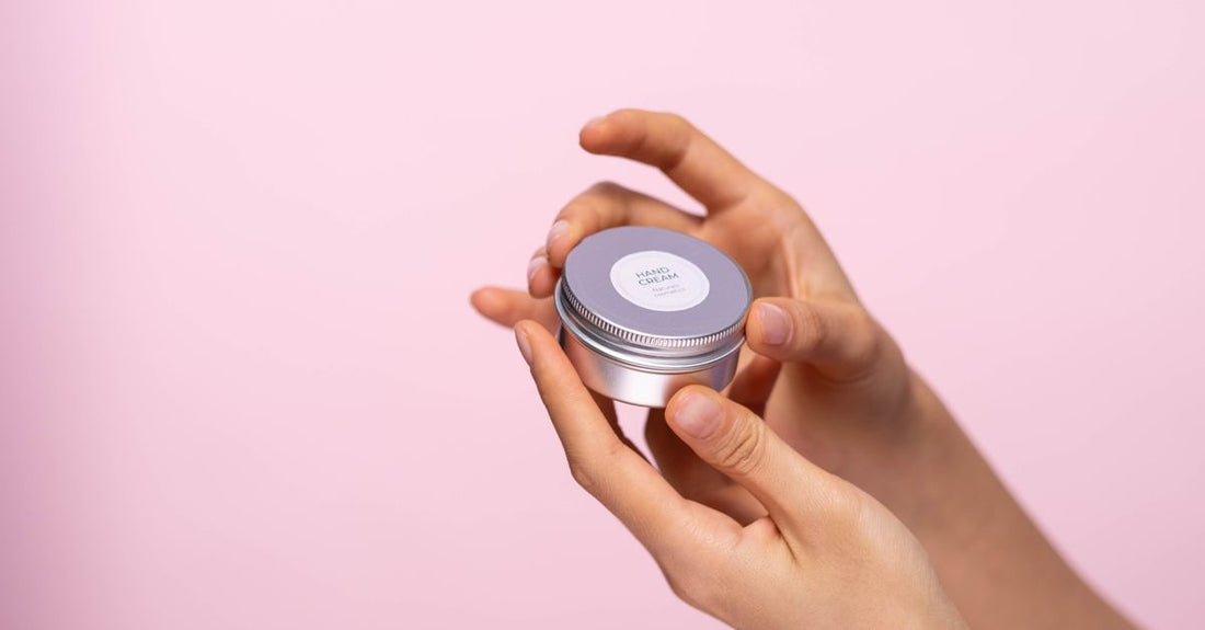 A white jar of aftercare cream with botanical extracts on a clean surface, illustrating how to choose aftercare products for optimal healing.