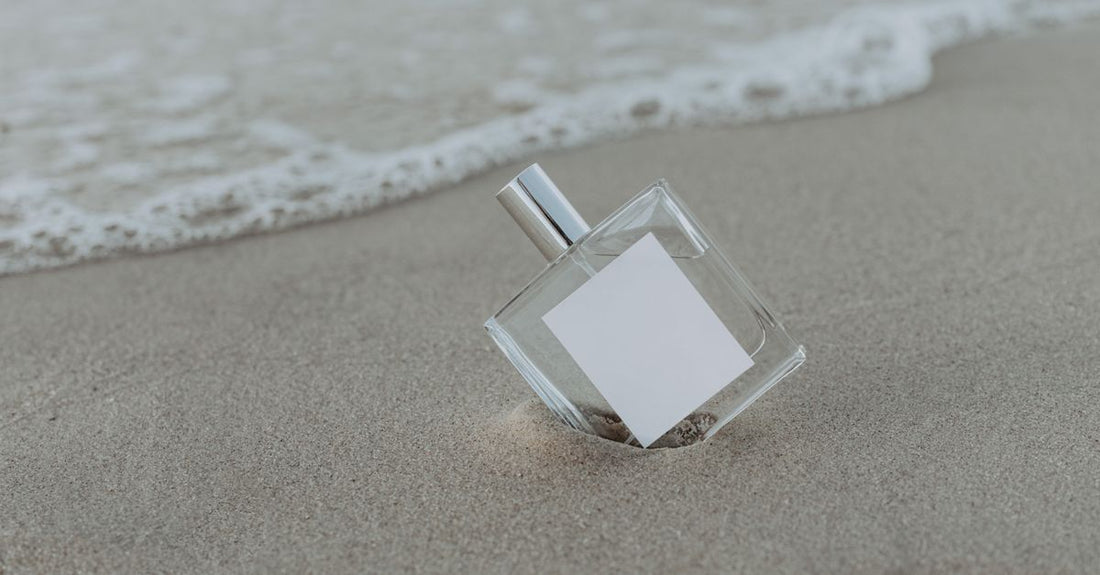 A lineup of sleek body spray bottles on a minimalist tray, representing the best body sprays 2026 for long-lasting scent.