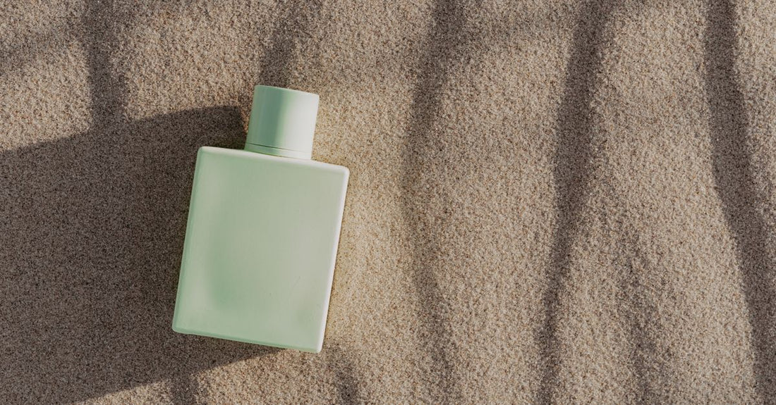 Elegant perfume bottle on a marble surface with soft lighting, illustrating how to make perfume last longer on skin.