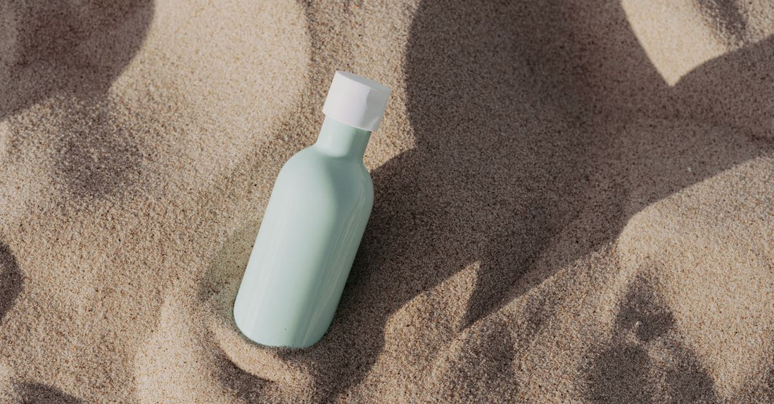 Self-tan mousse bottle on a bathroom shelf, body self-tanners buying guide UK
