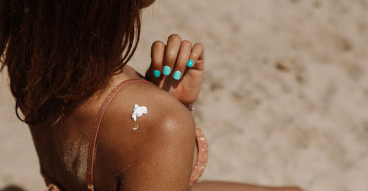 A bottle of gradual tan lotion on a bright, clean surface, representing how to apply gradual tan lotion for a natural glow.