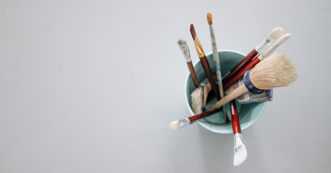 A flatlay arrangement of high-quality makeup brush sets in 2026, featuring synthetic bristles and sleek handles, on a marble background.