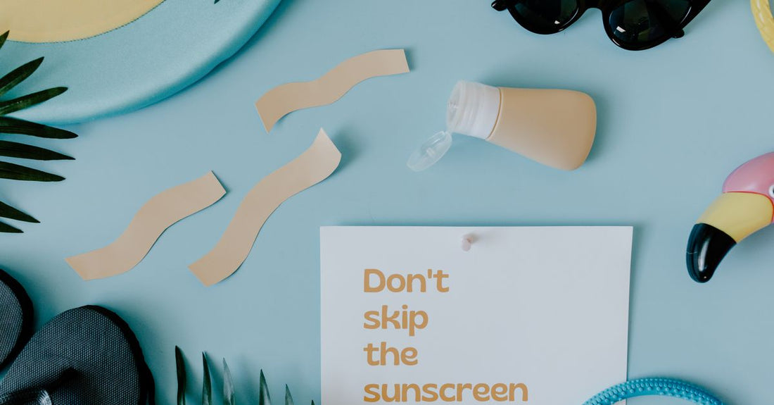 A flatlay of sunscreen bottles for acne-prone skin, including mineral and chemical options, on a clean white background.