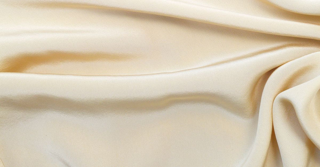An array of moisturiser jars and tubes arranged on a marble surface, illustrating how to choose creams for different skin types.