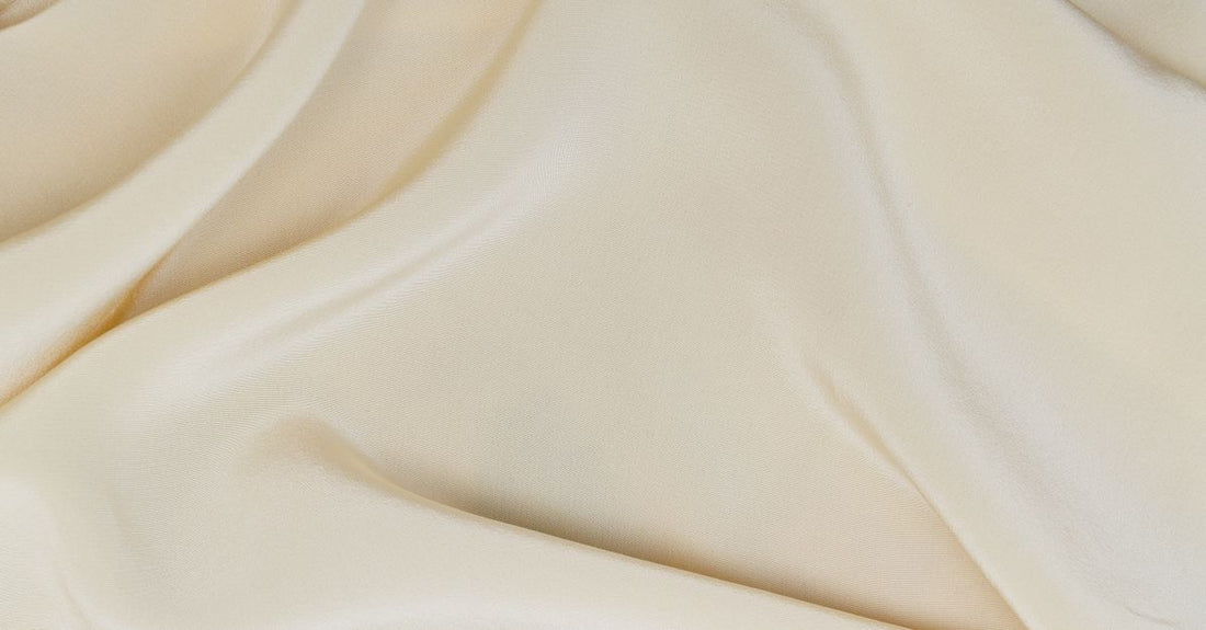 A collection of best creams 2026 displayed on a white marble surface, showcasing various jars and textures.