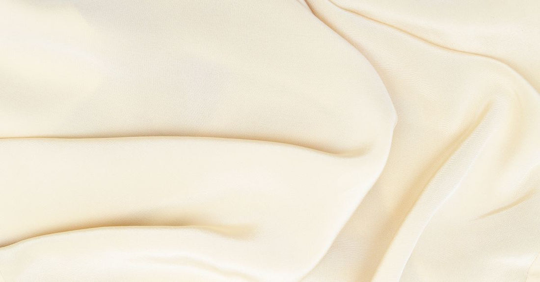 A collection of moisturiser jars on a marble surface, demonstrating textures for how to choose creams.
