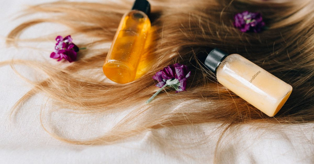 A selection of budget-friendly scalp acne treatment products on a clean surface, including clarifying shampoos and targeted spot treatments.