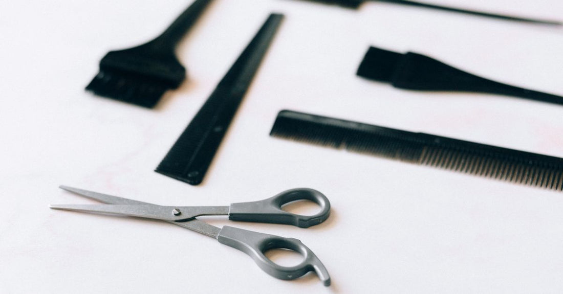 A selection of high-quality wooden and metal beard and mustache combs arranged on a neutral background, illustrating a beard & mustache combs buying guide.