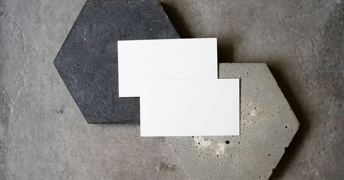A selection of premium business cards with different textures and finishes, illustrating how to choose business cards for a professional beauty brand.