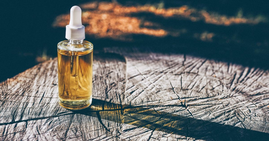 Collection of beard conditioners and oils on a rustic wooden surface, showcasing the best beard conditioners & oils 2026 for grooming.