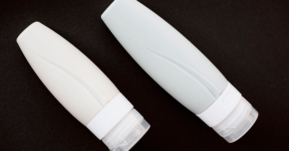 How to choose hand creams & lotions UK: a flatlay of various hand cream tubes and jars on a marble surface.