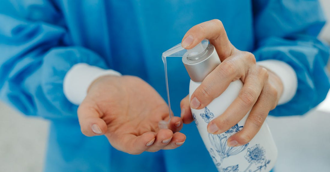 A hydrating hand sanitiser bottle on a bathroom shelf, illustrating how to use hand sanitizer without drying hands.
